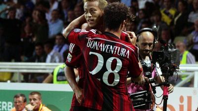 Giacomo Bonaventura, near, celebrates with Keisuke Honda after scoring AC Milan's opening goal in their win over Parma in Serie A on Sunday. Elisabetta Baracchi / EPA / September 14, 2014
