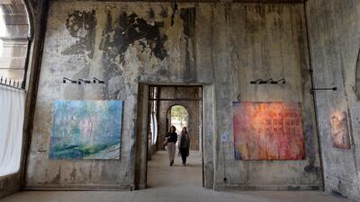 Visitors viewing paintings by 45-year-old British artist Tom Young during an exhibition at the Sawfar Grand Hotel in the village of Sawfar southeast Beirut, Lebanon. EPA