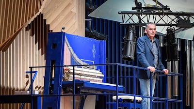 Piano constructor and builder David Klavins stands next to his new creation. AFP