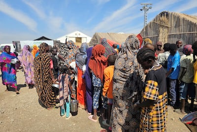 Displaced Sudanese people wait to receive humanitarian aid at the Abu Al Naga displacement camp in Gedaref state. AFP