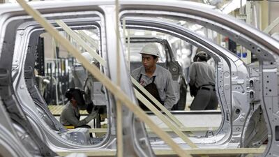 A worker inspects a body of Datsun Go+ at an assembly line in the Nissan Indonesia factory. Beawiharta / Reuters