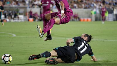 Manchester City's Kyle Walker, top, avoids a tackle from Real Madrid's Gareth Bale. Jae C Hong / AP Photo