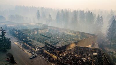Smoke hangs over the scorched remains of Old Town Plaza. AP Photo