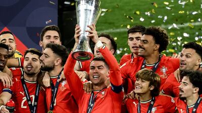 Cristiano Ronaldo of Portugal lifts the trophy as players celebrate after winning the Uefa Nations League final. EPA