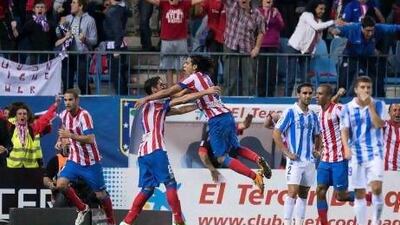 Radamel Falcao, right, took his season's tally to nine goals with his brace for Atletico Madrid against Malaga. Alberto Di Lolli / AP Photo