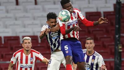 Atletico Madrid midfielder Thomas Partey and Valladolid´s Matheus Fernandes compete for a header. EPA