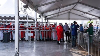 Butchers wait for livestock to be processed inside the slaughter house.