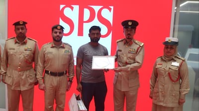 Mohammed Riyadh, a driver, was given a gift by Dubai Police after handing in cash he found in his car. Photo: Dubai Police