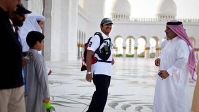 Surrounded by friends and family, Fadhel Khouri starts his walk on Thursday at the Sheikh Zayed Grand Mosque.
