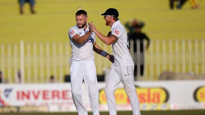 England's Gus Atkinson, left, celebrates after taking the wicket of Pakistan's Saud Shakeel. AP