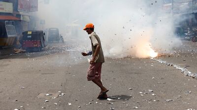 A supporter celebrates in Colombo after Mr Wickremesinghe was elected as president. Reuters
