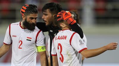 Ibrahim Alma, centre, of Syria praises defenders Ahmad Al Saleh, left, and Mouaiad Al Ajaan. Getty Images