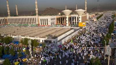 Muslim pilgrims walk past the Namirah mosque on Mount Arafat. AP Photo