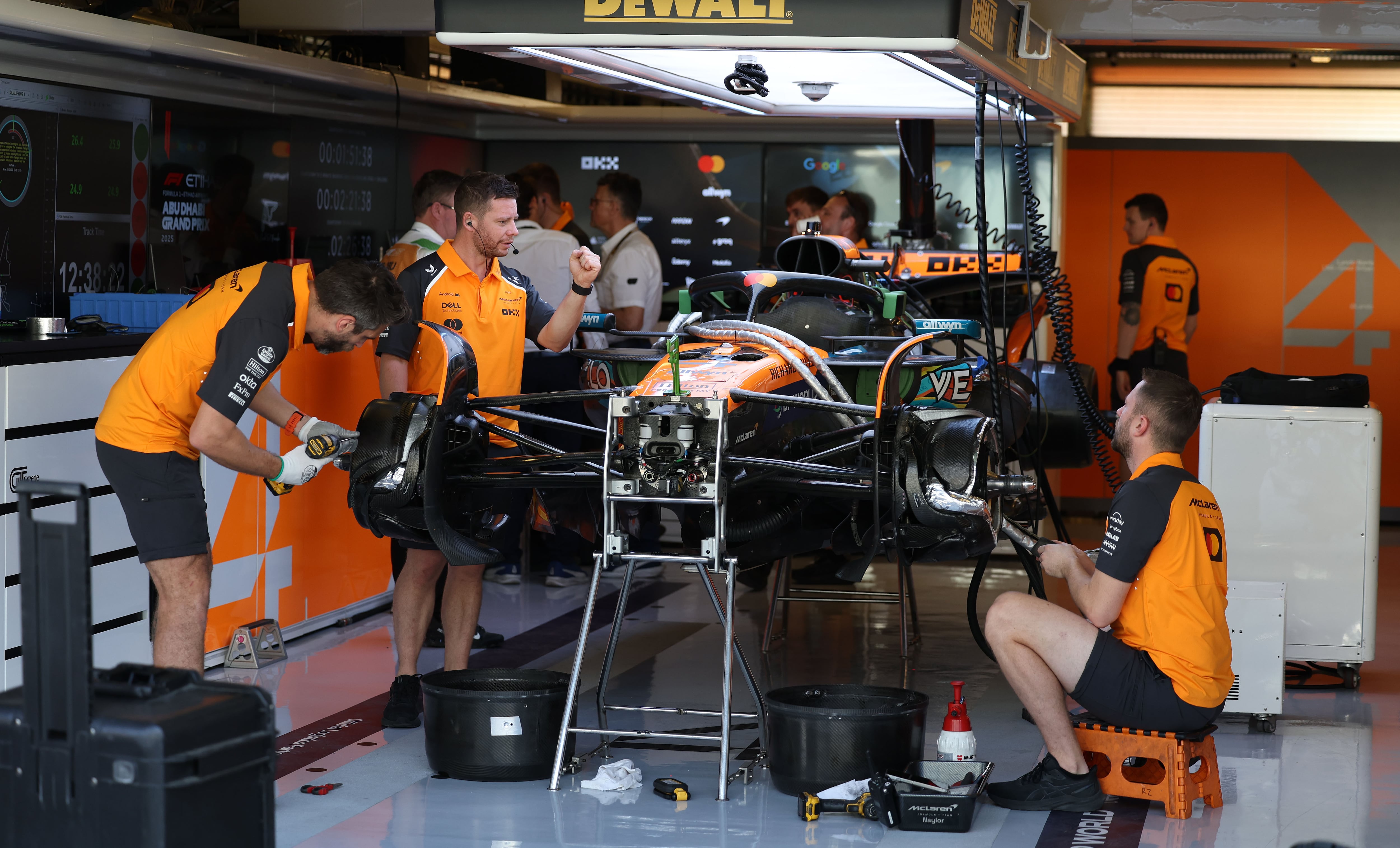 McLaren engineers work on the car on Sunday