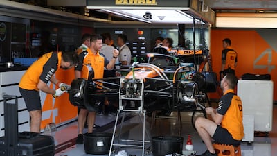 McLaren engineers work on the car on Sunday