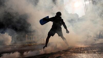 An anti-government protester throws an object during a demonstration on China's National Day, in Wong Tai Sin, Hong Kong. Reuters