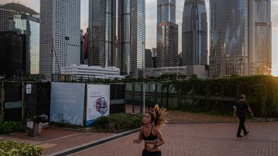 A jogger runs as buildings stand in the Central district in Hong Kong, China, on Monday, June 22, 2020. Bloomberg