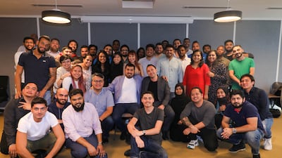 George Karam, seated centre, and his team at The Cloud, a food technology start-up based in Abu Dhabi's Hub71. Photo: The Cloud