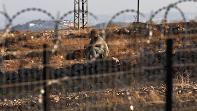 A masked Israeli settler on a Palestinian property in the West Bank village of Taybeh. EPA
