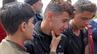 Young people mourn the four children killed on their way to school on Monday, in Syria's rebel-held Idlib province. AFP