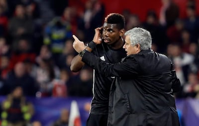 Manchester United manager Jose Mourinho, right, talks to midfielder Paul Pogba during the Champions League match against Sevilla. Miguel Morenatti / AP Photo