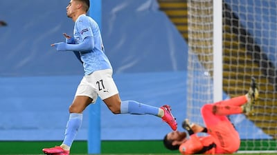 Manchester City's Portuguese defender Joao Cancelo (L) celebrates scoring his team's third goal during the UEFA Champions League football Group C match between Manchester City and Olympiakos at the Etihad Stadium in Manchester, north west England on November 3, 2020. AFP