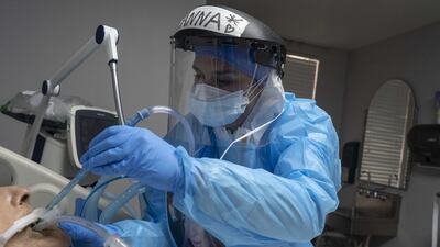 A medical staff member treats a patient suffering from coronavirus in the Covid-19 intensive care unit (ICU) at the United Memorial Medical Center in Houston, Texas. AFP