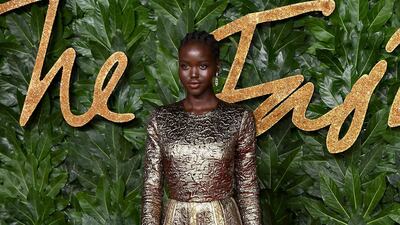 Clad in antiqued gold, Adut Akech looks fabulous. Getty
