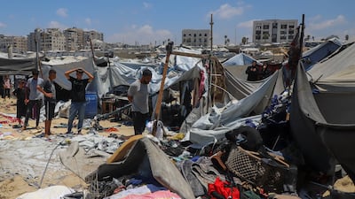 Palestinians inspect the site of an Israeli strike at a camp sheltering displaced people in Gaza city on Tuesday. Reuters