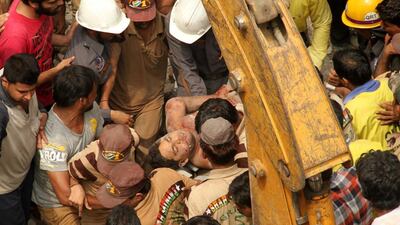 The four-storey building in New Delhi was in an area inhabitaed by the poor. EPA