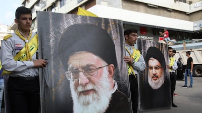 Hezbollah supporters carry posters of Hezbollah leader Hasan Nasrallah (R) and Iran's Supreme Leader Ayatollah Ali Khamenei during the funeral of three Hezbollah fighters killed in combat in Syria in 2017. Mahmoud Zayyat / AFP