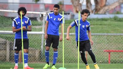 Midfielder Mohamed Abdulrahman, right, slaloms between sticks.