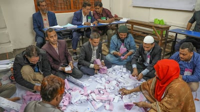Bangladesh election officials count ballots at Dhaka Government Muslim High School. EPA