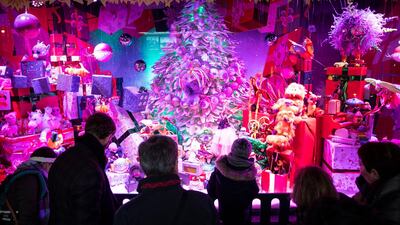 Passers-by, Christmas shoppers and tourists walk by and look at shop windows of the Galleries Lafayette in Paris, France. EPA