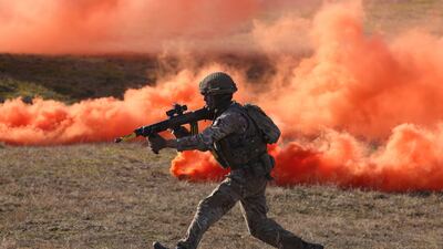 A soldier of the UK's Second Battalion Royal Anglian infantry unit storms an enemy position in a simulated attack during the Nato 'Brilliant Jump' military exercises. Getty Images