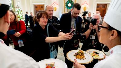 A trio of American cheeses and other dishes are displayed. AP