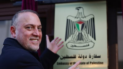 Mr Zomlot poses at the entrance to the new embassy. EPA