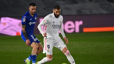 Real Madrid's Karim Benzema closely watched by Getafe defender Erick Cabaco. AFP