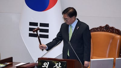South Korea's National Assembly speaker Woo Won-shik passes a resolution demanding the immediate lifting of martial law at the National Assembly. AFP