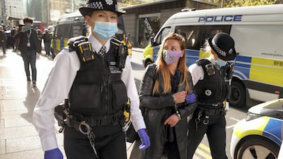 Police lead away one of the activists. Reuters