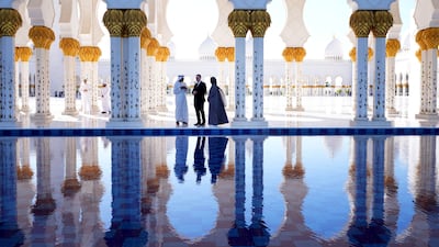 Mr Starmer is led by Sheikh Zayed Grand Mosque's director general Yousef Al Obaidli and tour guide Mahra as he tours the site. Reuters