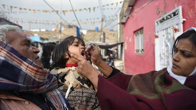 A Pakistani health worker administers polio vaccine drops to a child during a polio vaccination campaign in Islamabad on December 12, 2018. AFP