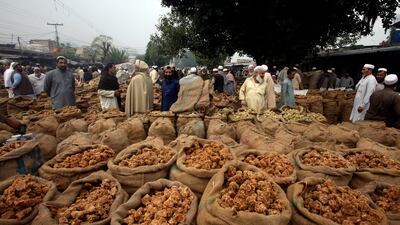 Merchants selling Gurr, or condensed sugarcane juice, wait for customers in Peshawar, Pakistan. AP
