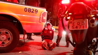 Police detain a person after supporters of Jair Bolsonaro and Fernando Haddad clashed in Sao Paulo. REUTERS