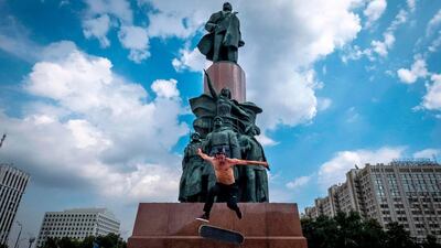 A skateboarder performs a trick in front of a monument to the Soviet Union founder Vladimir Lenin in Moscow. AFP