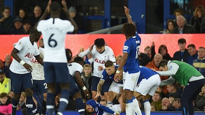 Everton's Portuguese midfielder Andre Gomes is comforted by his Everton teammates and Spurs players after his terrible injury. AFP