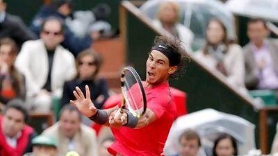 Rafael Nadal returns to Novak Djokovic during their men's final match in the French Open at Roland Garros. Rain interrupted play twice, the second time causing the match to be pushed back to Monday.