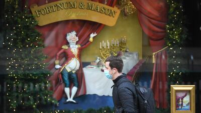 A man passes Christmas decorations in Picadilly in London. EPA