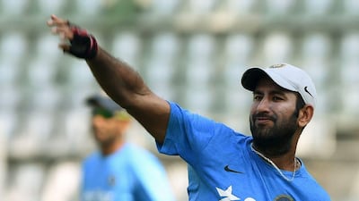 India’s Cheteshwar Pujara throws a ball during training. Punit Paranjpe / AFP