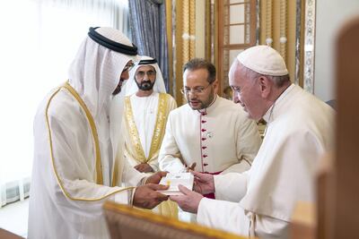 ABU DHABI, UNITED ARAB EMIRATES - February 4, 2019: Day two of the UAE papal visit - His Holiness Pope Francis, Head of the Catholic Church (R), presents a gift to HH Sheikh Mohamed bin Zayed Al Nahyan, Crown Prince of Abu Dhabi and Deputy Supreme Commander of the UAE Armed Forces (L), during an official reception at the Presidential Palace. ( Ryan Carter / Ministry of Presidential Affairs ) ---